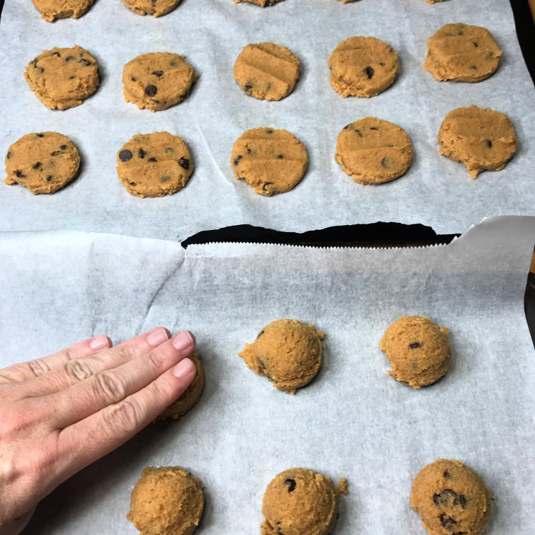 pressing pumpkin cookie dough down