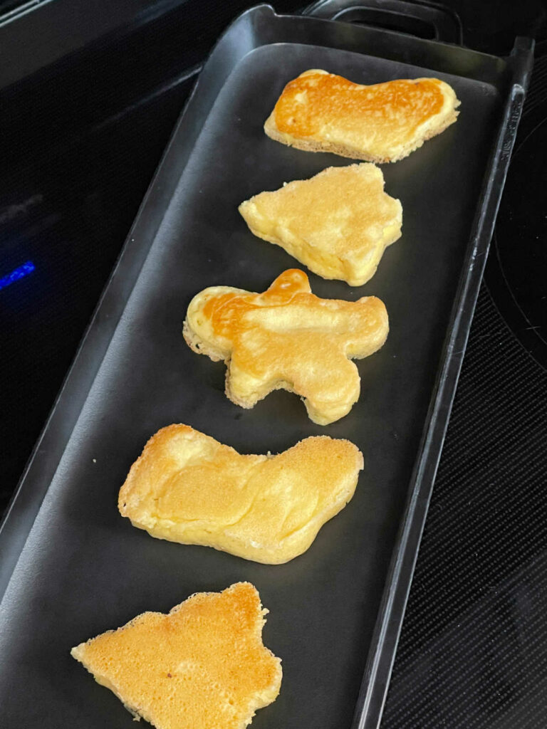 Keto Cookie Cutter Pancakes on the griddle tray