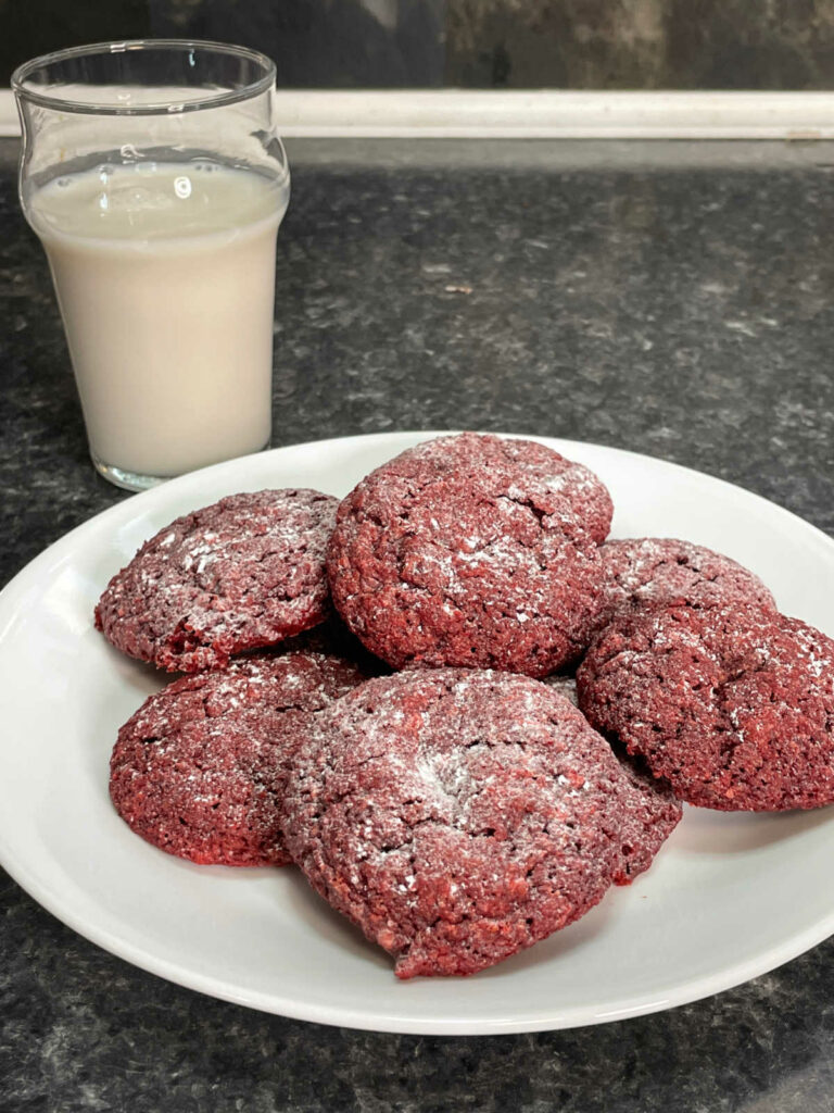 Keto Red Velvet Crinkle Cookies plated with milk