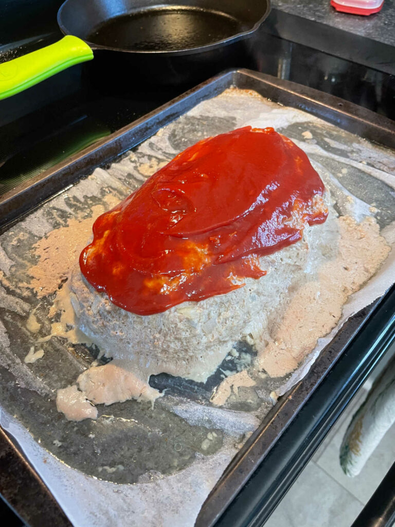 Keto Beef and Turkey Meatloaf adding ketchup