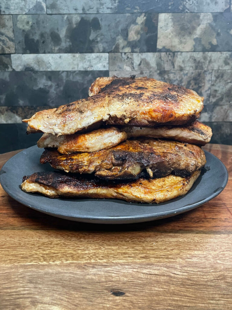 Skillet Fried Pork Chops stacked on a plate