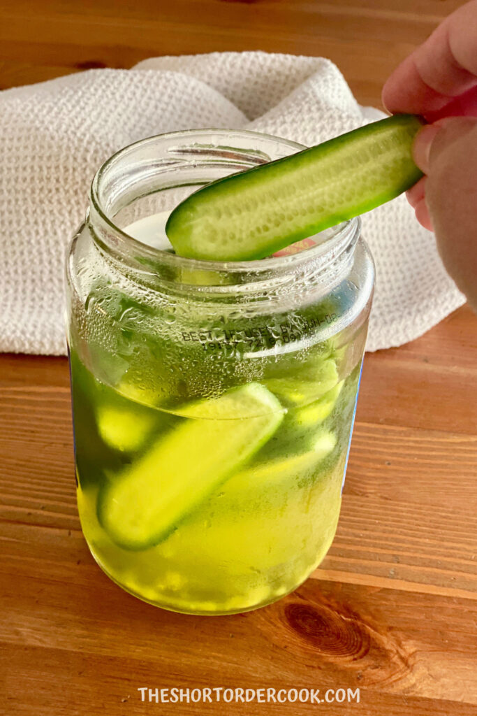 Homemade-Pickles-with-Leftover-Pickle-Juice-loading-into-the-jar-683x1024