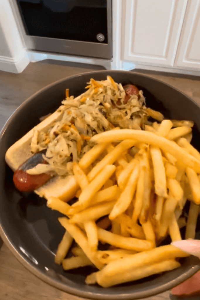 1. Plate of healthy homemade chicken salad with French fries, served in a black bowl.